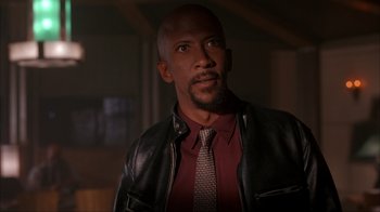 Movie still from “The Mask” (1994), directed by Chuck Russell – A man wearing a leather jacket and a tie; Close Up shot, Low angle