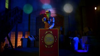 Movie still from “The Mask” (1994), directed by Chuck Russell – A man in a top hat and vest holding a wand; Wide shot, Low angle