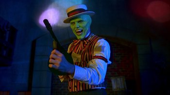 Movie still from “The Mask” (1994), directed by Chuck Russell – A man with a clown mask holding a baseball bat; Medium shot, Low angle