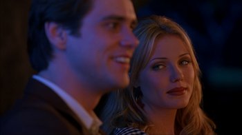 Movie still from “The Mask” (1994), directed by Chuck Russell – A man and a woman looking at the camera; Close Up shot, Over the shoulder angle