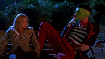 Movie still from “The Mask” (1994), directed by Chuck Russell – Two people sitting on a park bench at night; Medium shot, Over the shoulder angle