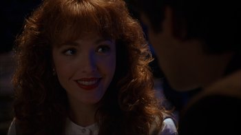 Movie still from “The Mask” (1994), directed by Chuck Russell – A person with curly red hair; Close Up shot, Over the shoulder angle