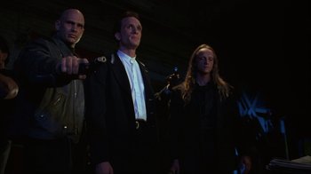 Movie still from “The Mask” (1994), directed by Chuck Russell – A group of people standing next to each other in the dark; Medium shot, Low angle
