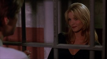 Movie still from “The Mask” (1994), directed by Chuck Russell – A woman standing in front of a window with a cat; Close Up shot, Over the shoulder angle