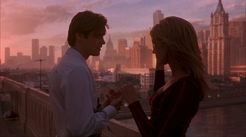 Movie still from “The Mask” (1994), directed by Chuck Russell – A man and a woman standing next to each other on top of a building; Medium shot, High angle