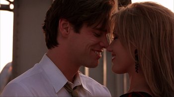 Movie still from “The Mask” (1994), directed by Chuck Russell – A man and a woman smiling at each other; Close Up shot, Low angle