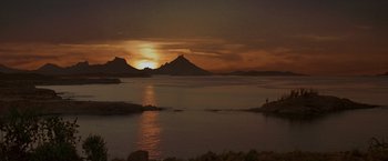 Movie still from “The Mask of Zorro” (1998), directed by Martin Campbell – The sun is setting over a body of water; Extreme Wide shot, High angle