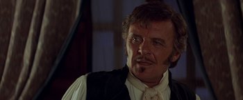 Movie still from “The Mask of Zorro” (1998), directed by Martin Campbell – A person wearing a suit and tie; Close Up shot, Over the shoulder angle