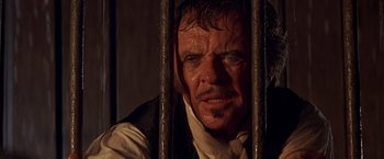 Movie still from “The Mask of Zorro” (1998), directed by Martin Campbell – A person behind a fence; Close Up shot, Over the shoulder angle