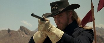 Movie still from “The Mask of Zorro” (1998), directed by Martin Campbell – A man with a hat and gloves holding a gun; Close Up shot, Low angle