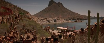 Movie still from “The Mask of Zorro” (1998), directed by Martin Campbell – A group of people standing on top of a sandy beach; Extreme Wide shot, High angle