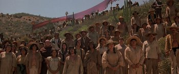 Movie still from “The Mask of Zorro” (1998), directed by Martin Campbell – A group of people standing on top of a hill; Wide shot, High angle