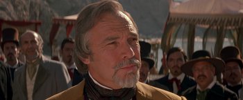 Movie still from “The Mask of Zorro” (1998), directed by Martin Campbell – An older man with a beard and mustache wearing a suit; Close Up shot, Low angle