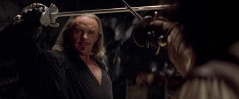 Movie still from “The Mask of Zorro” (1998), directed by Martin Campbell – A man standing in front of a camera; Close Up shot, Over the shoulder angle