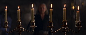 Movie still from “The Mask of Zorro” (1998), directed by Martin Campbell – Two lit candles in front of an older woman; Close Up shot, Over the shoulder angle