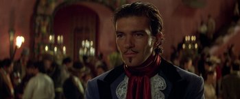 Movie still from “The Mask of Zorro” (1998), directed by Martin Campbell – A person wearing a suit and tie; Close Up shot, Low angle