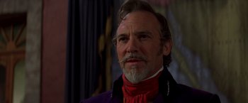 Movie still from “The Mask of Zorro” (1998), directed by Martin Campbell – An older man wearing a purple jacket and a red scarf; Close Up shot, Low angle