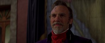 Movie still from “The Mask of Zorro” (1998), directed by Martin Campbell – An older man with a beard and a red scarf; Close Up shot, Low angle