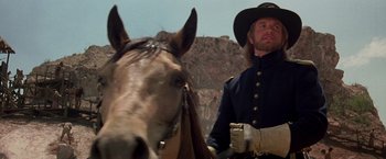 Movie still from “The Mask of Zorro” (1998), directed by Martin Campbell – A man wearing a hat standing next to a horse; Close Up shot, Low angle