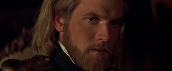 Movie still from “The Mask of Zorro” (1998), directed by Martin Campbell – A person with long hair and a beard; Close Up shot, Over the shoulder angle