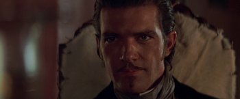 Movie still from “The Mask of Zorro” (1998), directed by Martin Campbell – A person wearing a suit and tie; Close Up shot, Over the shoulder angle