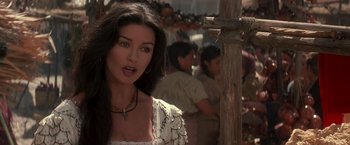 Movie still from “The Mask of Zorro” (1998), directed by Martin Campbell – A beautiful woman in a white dress standing in front of a crowd; Close Up shot, Over the shoulder angle