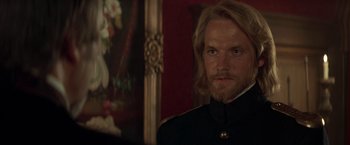 Movie still from “The Mask of Zorro” (1998), directed by Martin Campbell – A person with long blond hair; Close Up shot, Over the shoulder angle