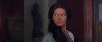Movie still from “The Mask of Zorro” (1998), directed by Martin Campbell – A woman with long black hair looking at the camera; Close Up shot, Over the shoulder angle