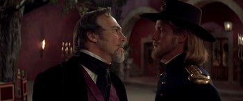 Movie still from “The Mask of Zorro” (1998), directed by Martin Campbell – A man and a man in a uniform face each other; Close Up shot, Over the shoulder angle