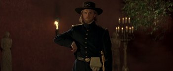 Movie still from “The Mask of Zorro” (1998), directed by Martin Campbell – A man in a uniform and a hat; Medium shot, Low angle