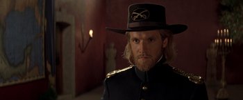 Movie still from “The Mask of Zorro” (1998), directed by Martin Campbell – A person wearing a uniform and a hat; Close Up shot, Over the shoulder angle