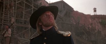 Movie still from “The Mask of Zorro” (1998), directed by Martin Campbell – A person wearing a uniform and a hat; Close Up shot, Low angle
