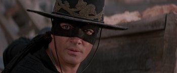 Movie still from “The Mask of Zorro” (1998), directed by Martin Campbell – A person wearing a hat and a mask; Close Up shot, Over the shoulder angle