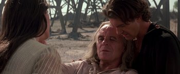 Movie still from “The Mask of Zorro” (1998), directed by Martin Campbell – A man and a woman are sitting in a field; Close Up shot, Over the shoulder angle