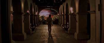 Movie still from “The Mask of Zorro” (1998), directed by Martin Campbell – A person is walking in a tunnel at night; Wide shot, Over the shoulder angle