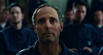 Movie still from “The Master” (2012), directed by Paul Thomas Anderson – A person looking at the camera; Close Up shot, Low angle
