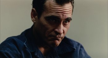 Movie still from “The Master” (2012), directed by Paul Thomas Anderson – A person wearing a blue shirt; Close Up shot, Low angle