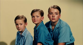 Movie still from “The Master” (2012), directed by Paul Thomas Anderson – Three young boys are posing for a picture; Medium shot, High angle