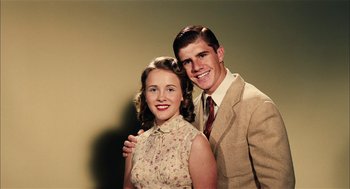 Movie still from “The Master” (2012), directed by Paul Thomas Anderson – A man and a woman posing for a picture; Close Up shot, High angle