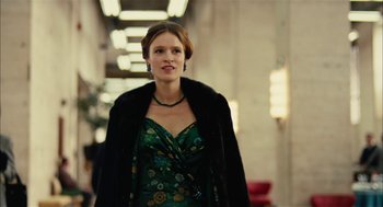 Movie still from “The Master” (2012), directed by Paul Thomas Anderson – A woman in a green dress and a fur coat; Medium shot, Low angle