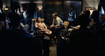 Movie still from “The Master” (2012), directed by Paul Thomas Anderson – A man and a woman are sitting in a room; Wide shot, High angle