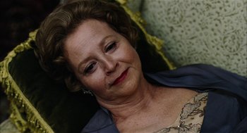 Movie still from “The Master” (2012), directed by Paul Thomas Anderson – An older woman is smiling for the camera; Close Up shot, High angle