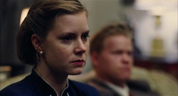Movie still from “The Master” (2012), directed by Paul Thomas Anderson – A woman and a man sitting next to each other in a room; Close Up shot, Over the shoulder angle