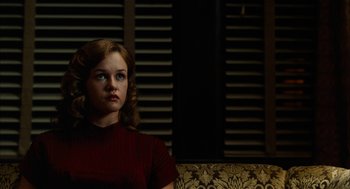 Movie still from “The Master” (2012), directed by Paul Thomas Anderson – A woman sitting on top of a couch in front of a window; Medium shot, Low angle