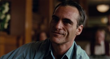 Movie still from “The Master” (2012), directed by Paul Thomas Anderson – A person wearing a blue shirt; Close Up shot, Over the shoulder angle