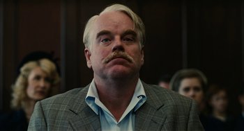 Movie still from “The Master” (2012), directed by Paul Thomas Anderson – An older man with a mustache and a beard; Close Up shot, Over the shoulder angle