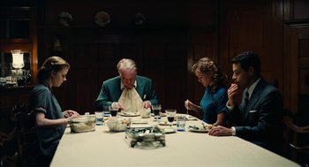 Movie still from “The Master” (2012), directed by Paul Thomas Anderson – A group of people sitting around a table eating; Medium shot, High angle