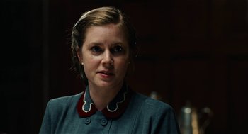 Movie still from “The Master” (2012), directed by Paul Thomas Anderson – A person wearing a dress; Close Up shot, Over the shoulder angle