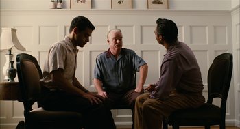 Movie still from “The Master” (2012), directed by Paul Thomas Anderson – A group of men sitting in a circle talking to each other; Medium shot, Over the shoulder angle
