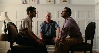 Movie still from “The Master” (2012), directed by Paul Thomas Anderson – A group of men sitting in a circle talking to each other; Medium shot, Low angle